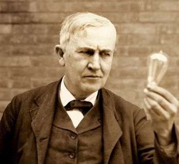 Thomas Edison holding light bulb